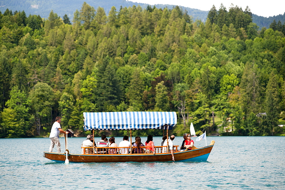 Tourists on a boat in Lake Bled in the Julian Alps in northwest Slovenia, Europe