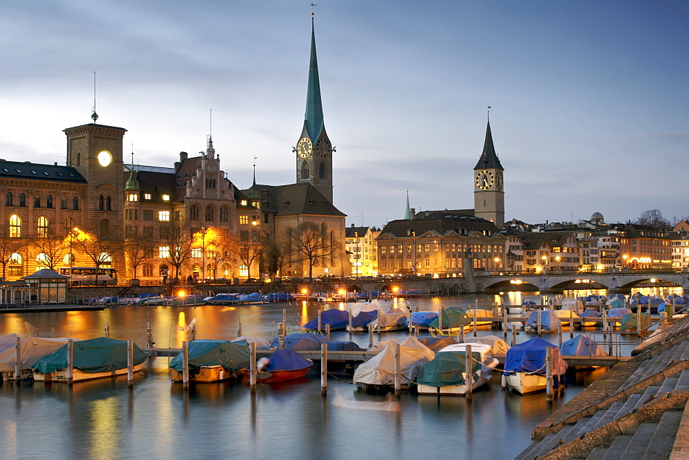 Dusk view of the Limmat River and old town of Zürich Switzerland.  The two churches are Fraumünster and St Peter's.