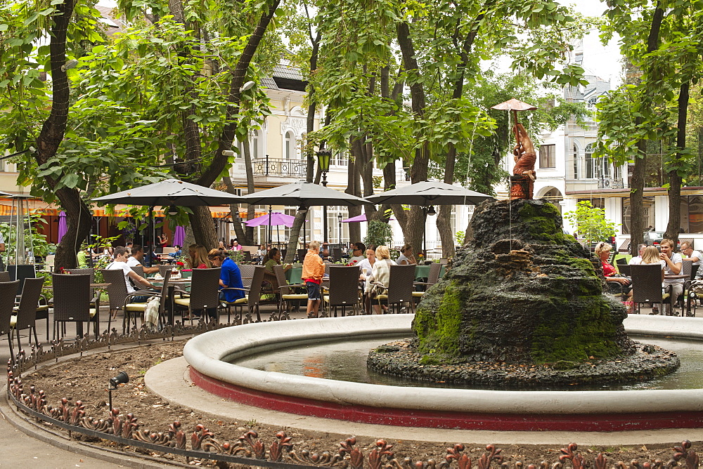 Fountain and restaurant tables in the Palais Royal Garden in Odessa, Ukraine, Europe