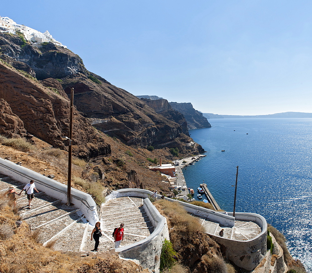 Tourists on the steps leading to the old port of Fira on the Greek island of Santorini, Cyclades, Greek Islands, Greece, Europe