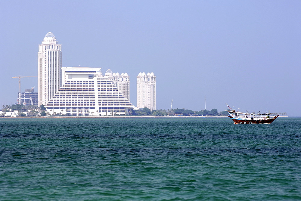 The Sheraton hotel on west bay and a ship in the bay in Doha in Qatar.