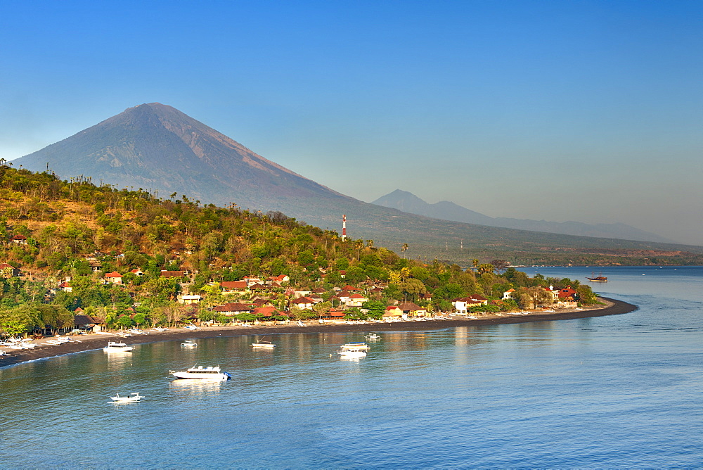 View of Mount Agung (3142m) and Jemulek beach and hamlet near Amed on the northeastern coast of Bali, Indonesia.