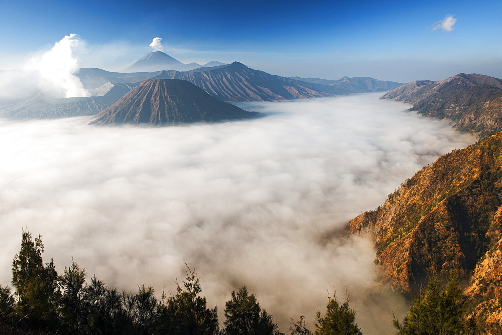 Mount Bromo (venting steam far left) and Gunung Semeru (background) in Bromo Tengger Semeru National Park, Java, Indonesia.