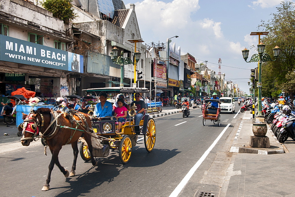 Horse drawn carriage on Jalan Malioboro, one of the main avenues in Yogyakarta, Java, Indonesia.