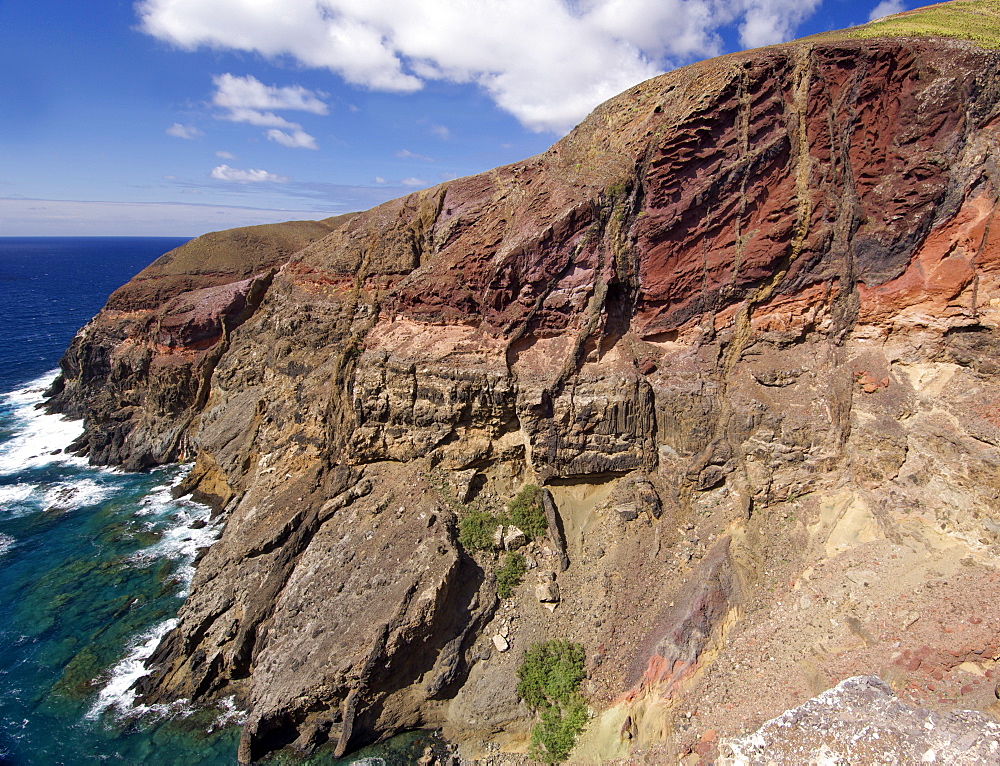 Coastal landscape at Ponta do Gabriel on the Portuguese Atlantic island of Porto Santo. The mountainside has slid away revealing signs of volcanic activity.