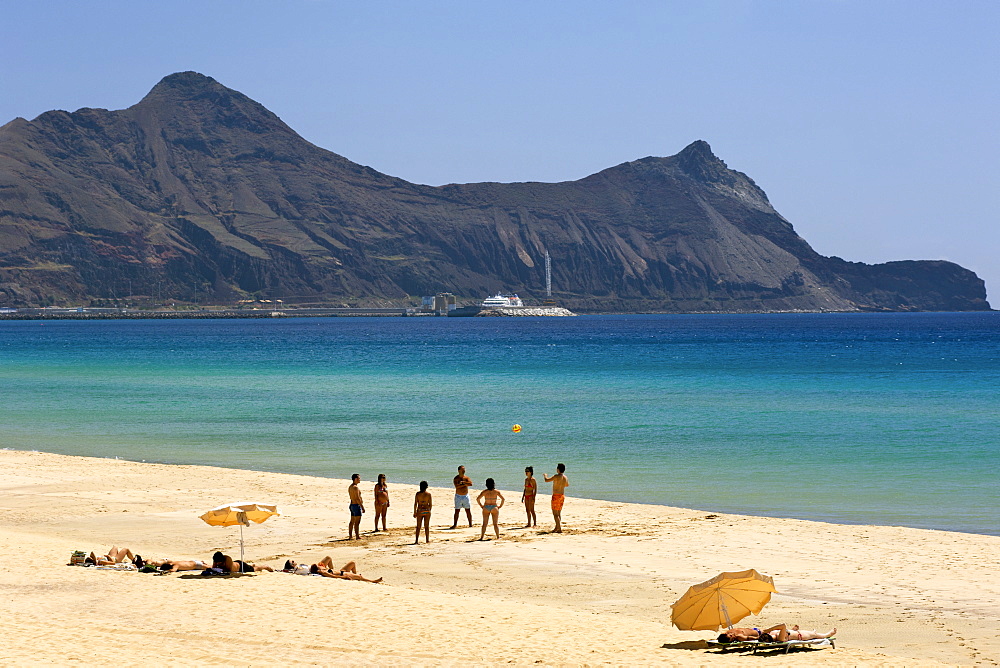 People playing ball on the beach of the Portuguese Atlantic island of Porto Santo.