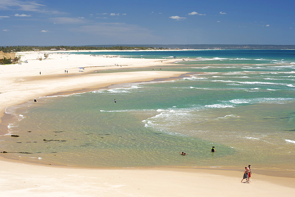 Couple strolling along the coast at Barra beach near Inhambane in southern Mozambique.