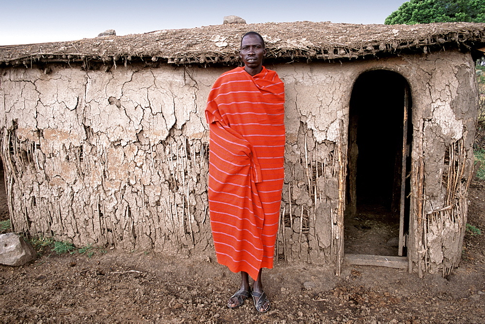 Portrait of a Maasai man outside his hut in his village (manyatta) in the Masai Mara, Kenya, East Africa, Africa