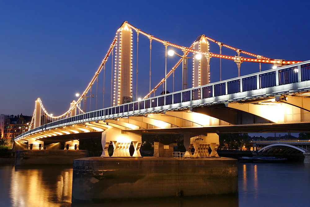 Dusk view of Chelsea Bridge which spans the Thames River in London.