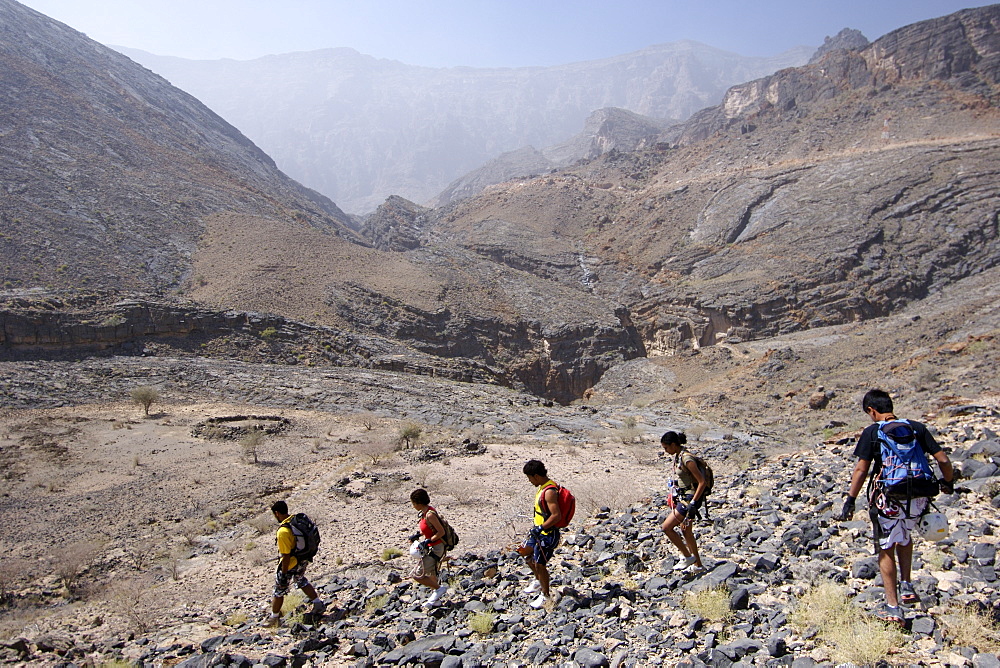 Hikers near Snake Canyon, part of Wadi Bani Auf in Jebel Akhdar of the western Hajar mountains in Oman.