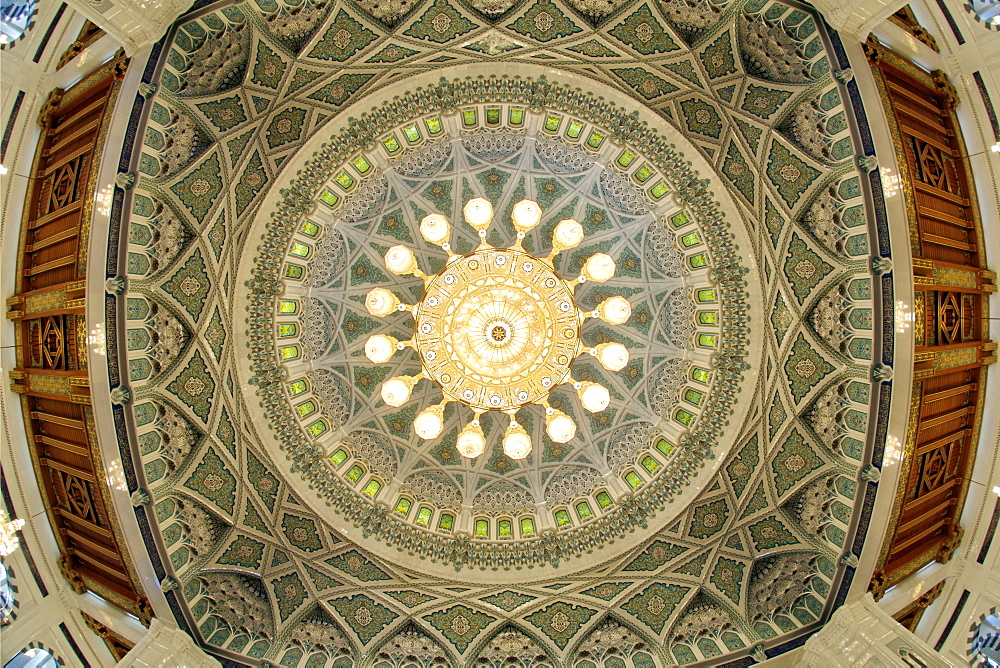 Fish-eye lens view of the chandelier and roof inside the prayer area of the Sultan Qaboos Grand Mosque in Muscat, the capital of Oman.