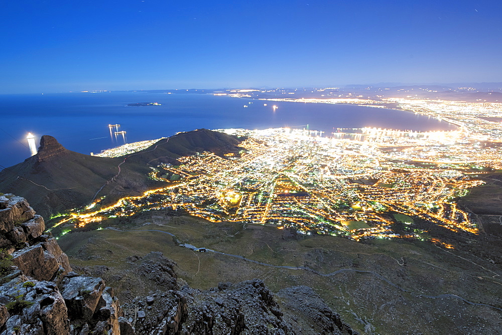 Night-time, moonlit view of the city of Cape Town from the summit of Table Mountain in South Africa.