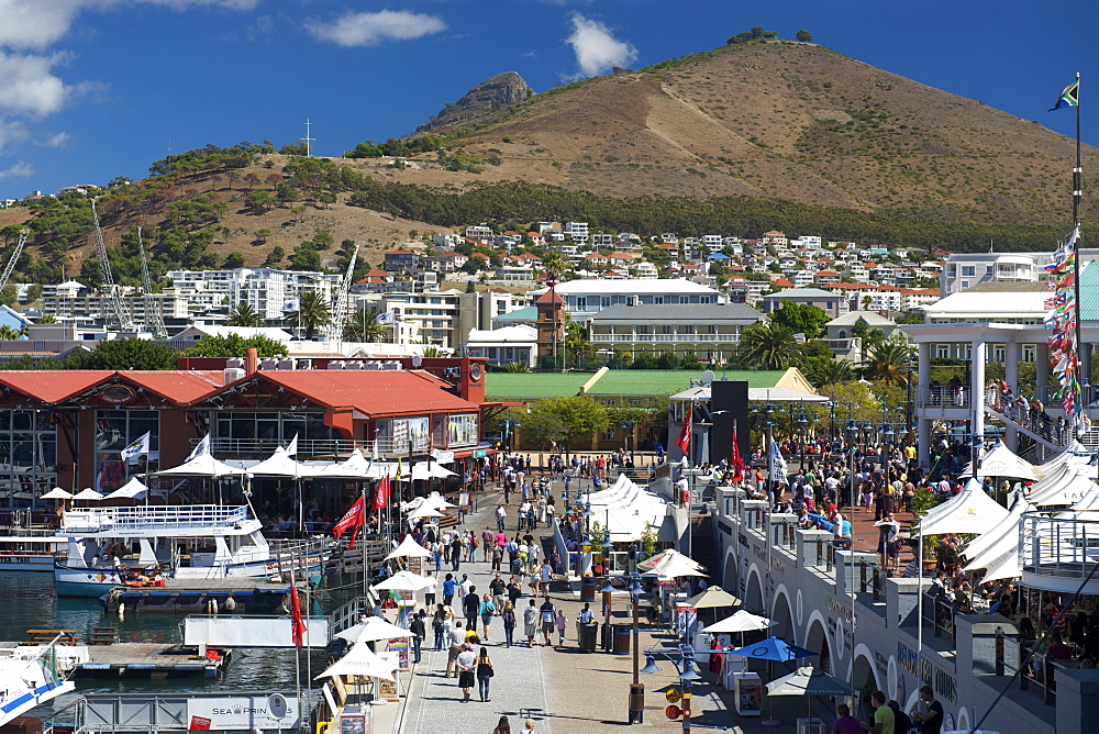 People walking through the waterfront in Cape Town, South Africa.