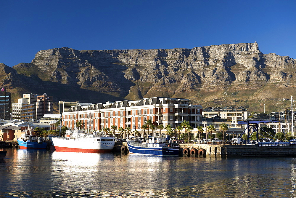 View of the Cape Grace hotel in the Cape Town waterfront with Table Mountain in the background.