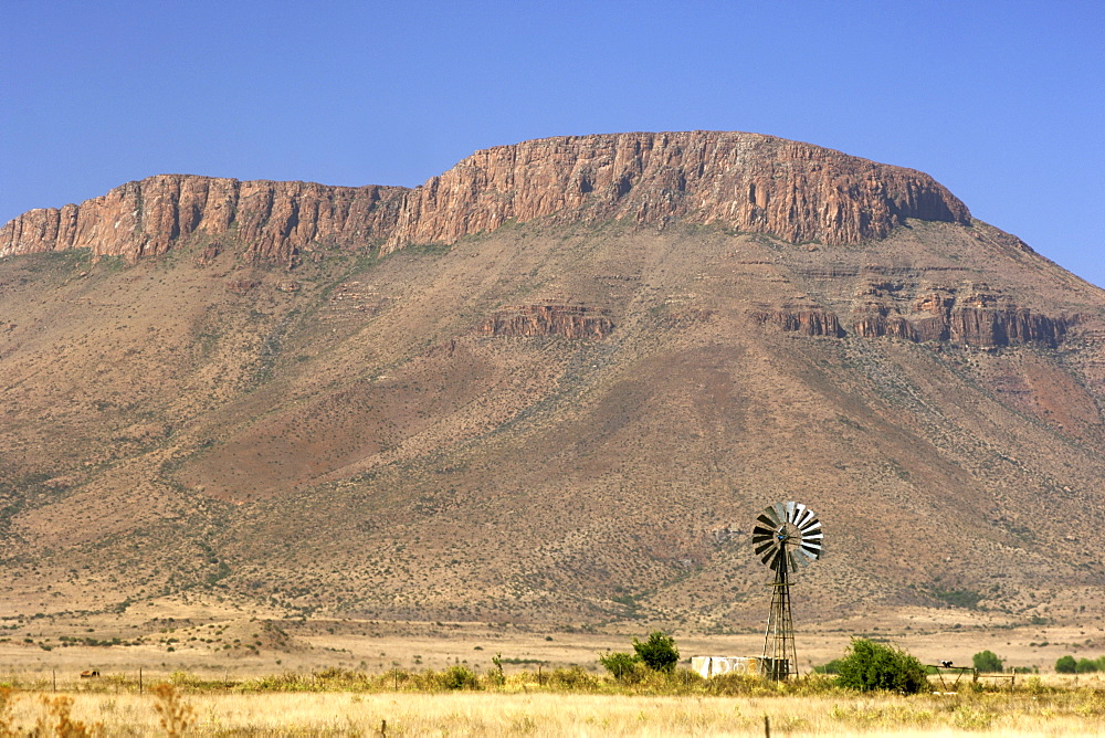 Mountains and a windmill between Graaf Reinet and Middelburg in the Karoo region of South Africa's Eastern Cape Province.