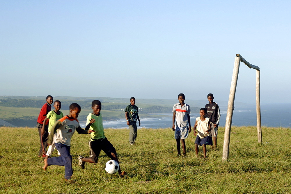 Young Xhosa boys playing football on a hill near Mazeppa Bay in the Eastern Cape Province of South Africa.