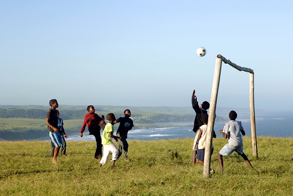 Young Xhosa boys playing football on a hill near Mazeppa Bay in the Eastern Cape Province of South Africa.