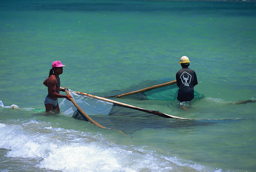 Men net fishing at Candidasa, Bali, Indonesia, Southeast Asia, Asia