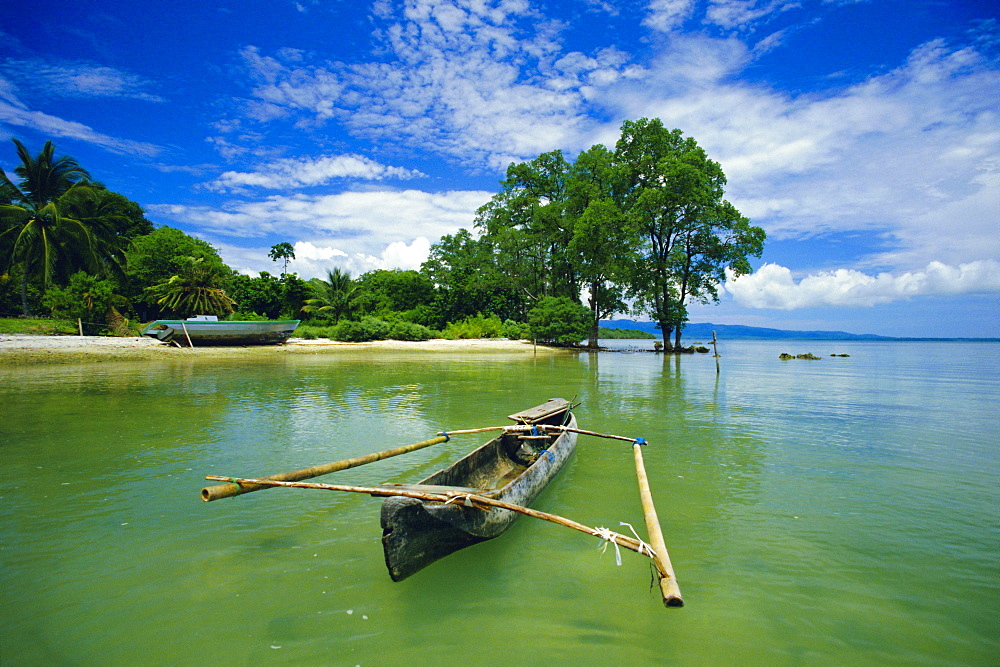 Outrigger canoe and beach, Ujong Kulon Reserve, Handeuleum Island, western Java, Indonesia