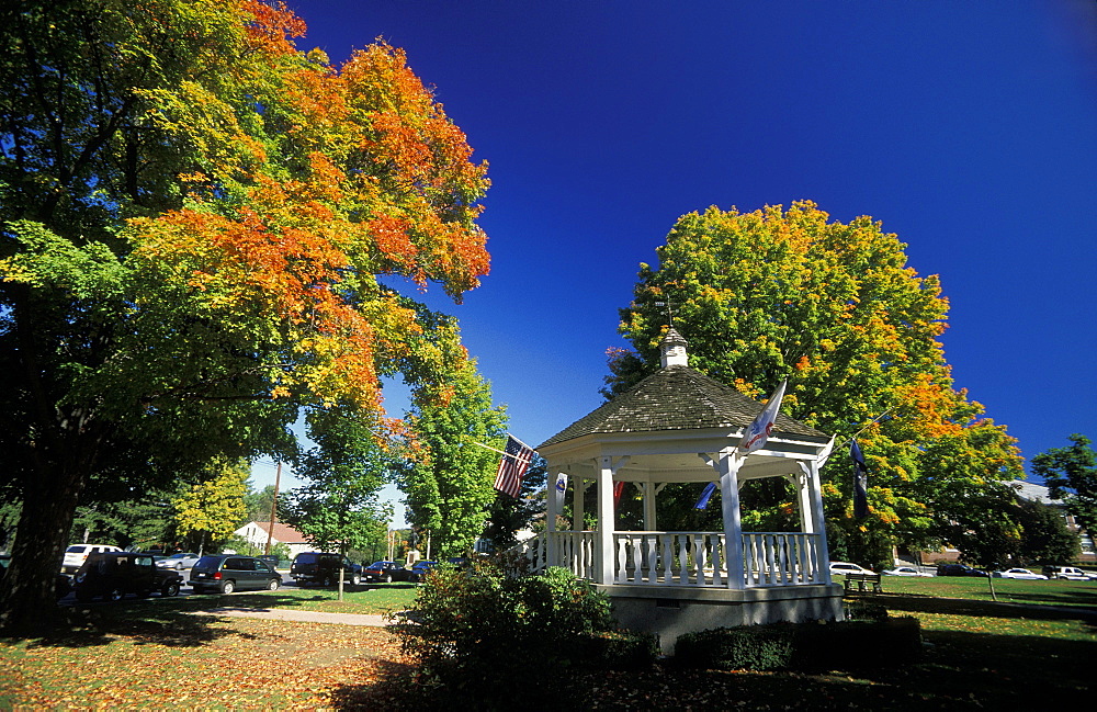 Autumn maple leaves in October, part of the beautiful New England fall display, round the band stand on the Town Common of Hopkinton, starting point of the Boston Marathon, Massachusetts, USA