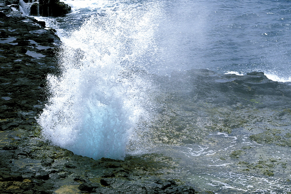 'The Spouting Horn' on the south coast near Poipu, where sea swell is forced through an old lava tube, making a strange noise, Kauai, Hawaii, USA