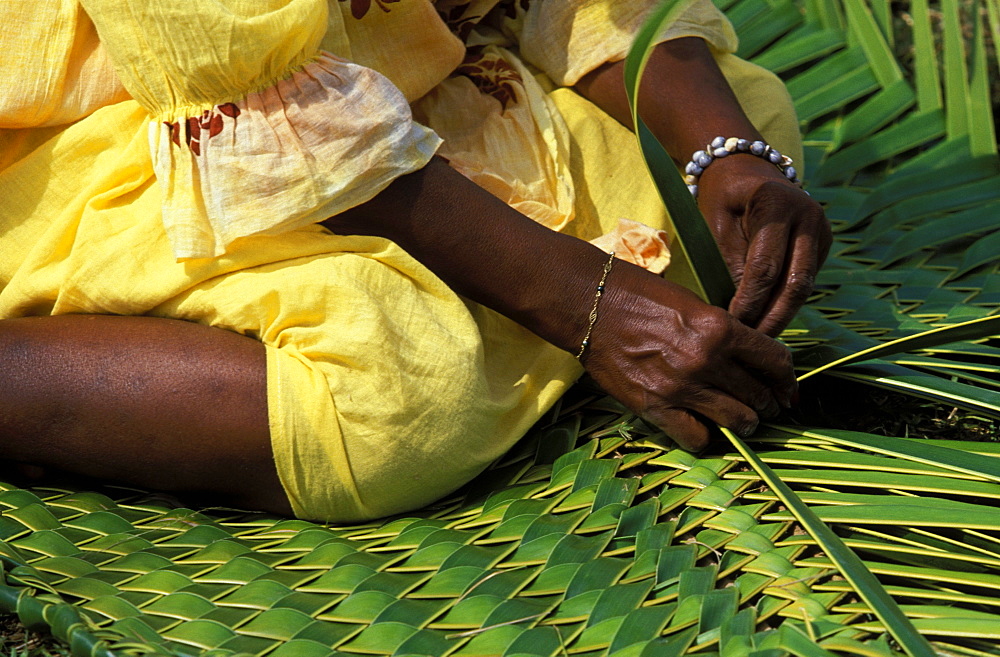 Woman weaving traditional pandanus mat at a Melanesian cultural festival, Efate Island, Port Vila, Vanuatu