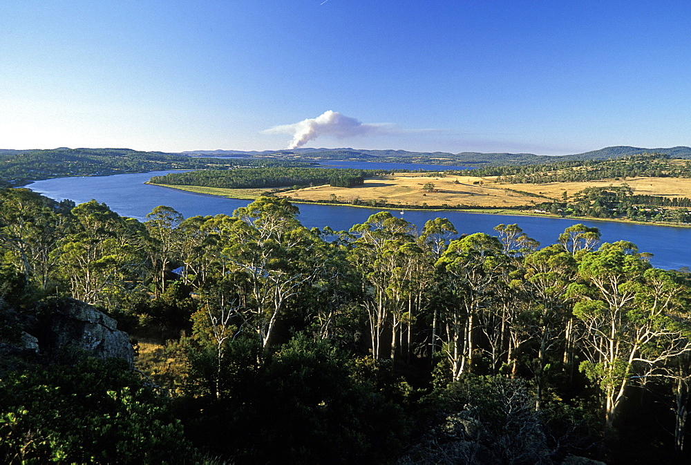 Looking north from Brady's Lookout State Reserve towards the Tamar River and a bush fire on horizon  in the state's premier wine region, the Tamar Valley, Tasmania, Australia, Pacific