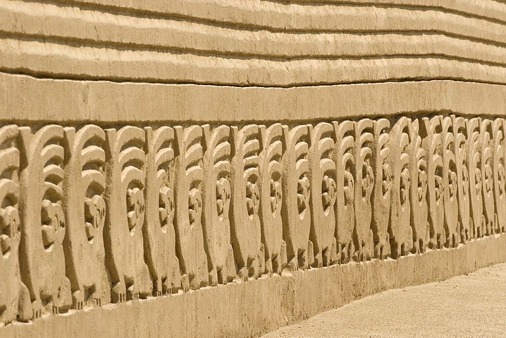 Restored wall with mythical bird motif in the Tschudi Complex, one of the ten 'ciudadelas' at Chan Chan,  pre-Columbian America's largest adobe city and capital of the Chimu Empire until its 14th century conquest by the Incas, Chan Chan, UNESCO World Heritage Site, Moche Valley, Trujillo, Peru, South America