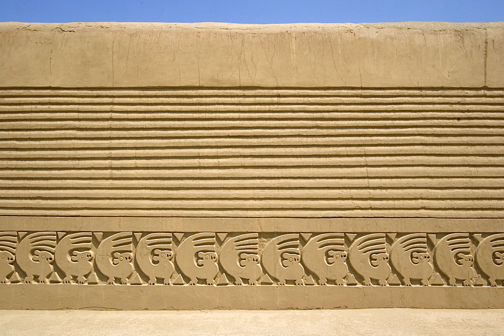 Restored wall with mythical bird motif in the Tschudi Complex, one of the ten 'ciudadelas' at Chan Chan,  pre-Columbian America's largest adobe city and capital of the Chimu Empire until its 14th century conquest by the Incas, Chan Chan, UNESCO World Heritage Site, Moche Valley, Trujillo, Peru, South America