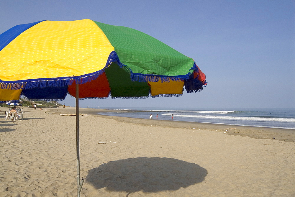 Parasol on the beach at this popular surfing resort in the far north near the Ecuadorean border, Mancora, Peru, South America

