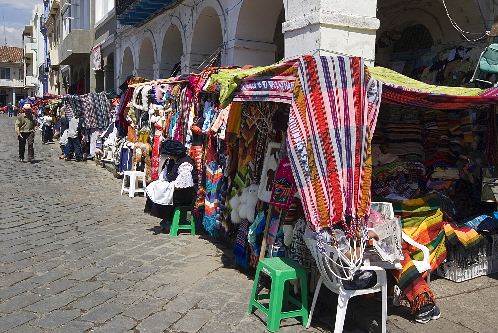 Colourful clothing and textiles for tourists in the market on Plaza San Francisco, Cuenca, Azuay Province, Southern Highlands, Ecuador, South America