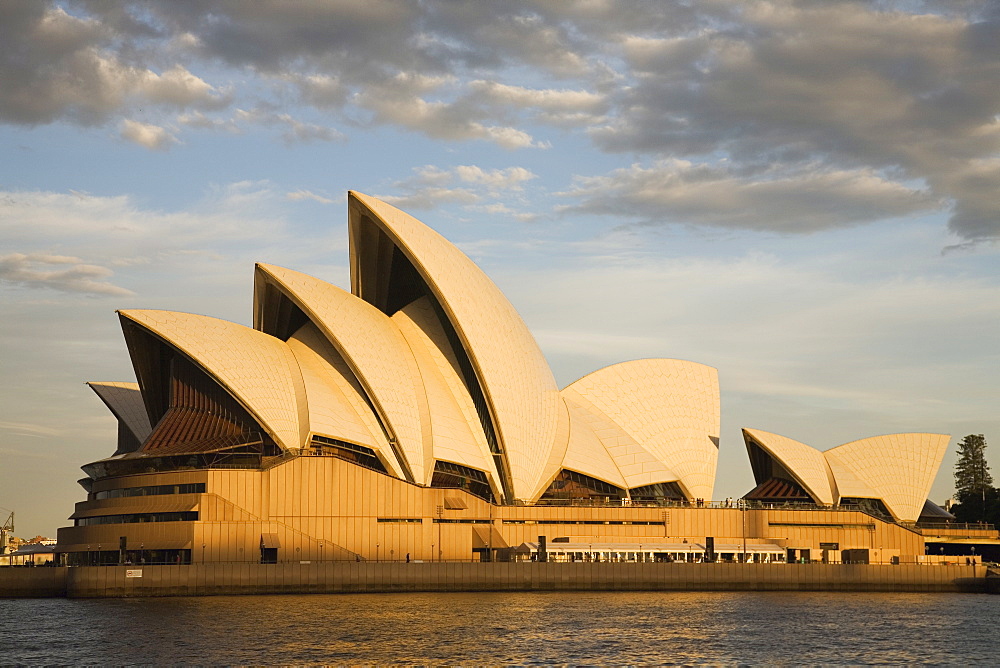 Sydney Opera House built in 1973, designed by Jorn Utzon, at Circular Quay, viewed at sunset, Sydney, New South Wales, Australia, Pacific