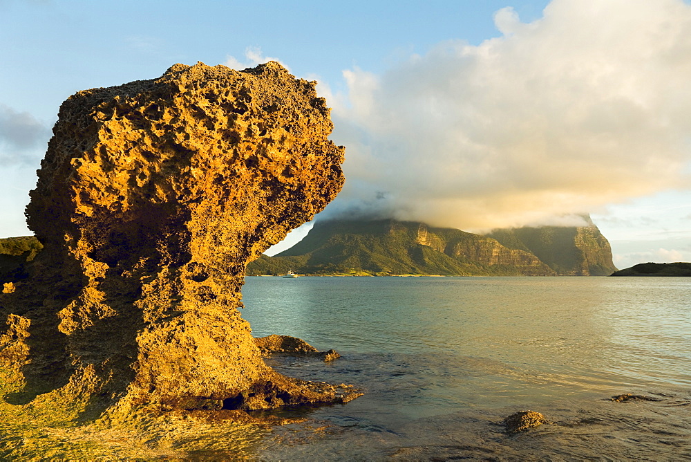 Eroded calcarenite rock (cemented coral sands) with Mount Lidgbird and Mount Gower by the lagoon with the world's most southerly coral reef, on this 10km long volcanic island in the Tasman Sea, Lord Howe Island, UNESCO World Heritage Site, New South Wales, Australia, Pacific Ocean.