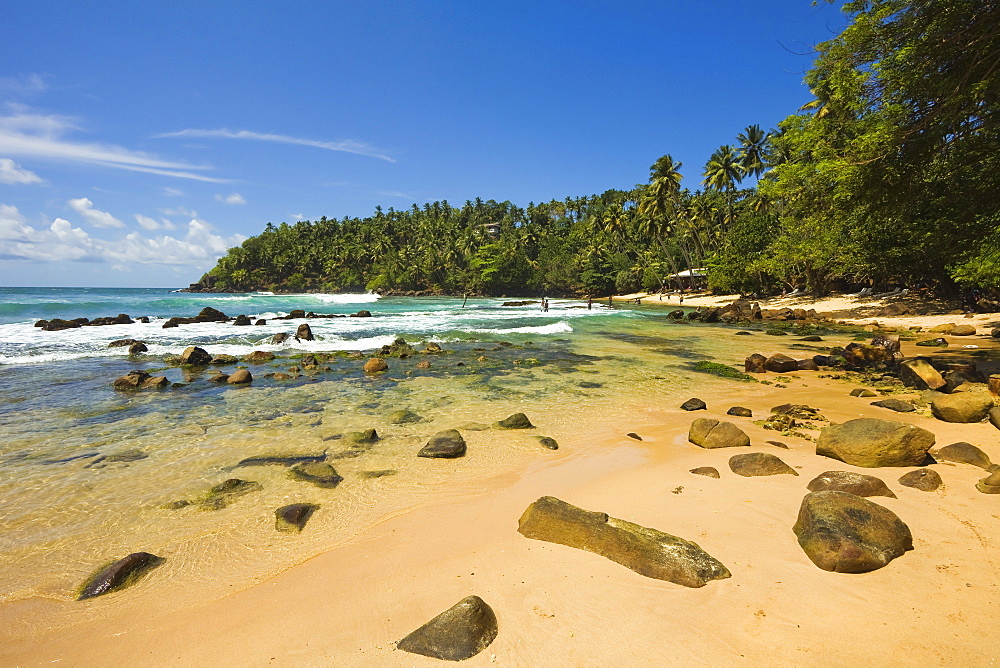 Western headland and surfing end of the south coast whale watch beach at Mirissa, near Matara, Southern Province, Sri Lanka, Asia