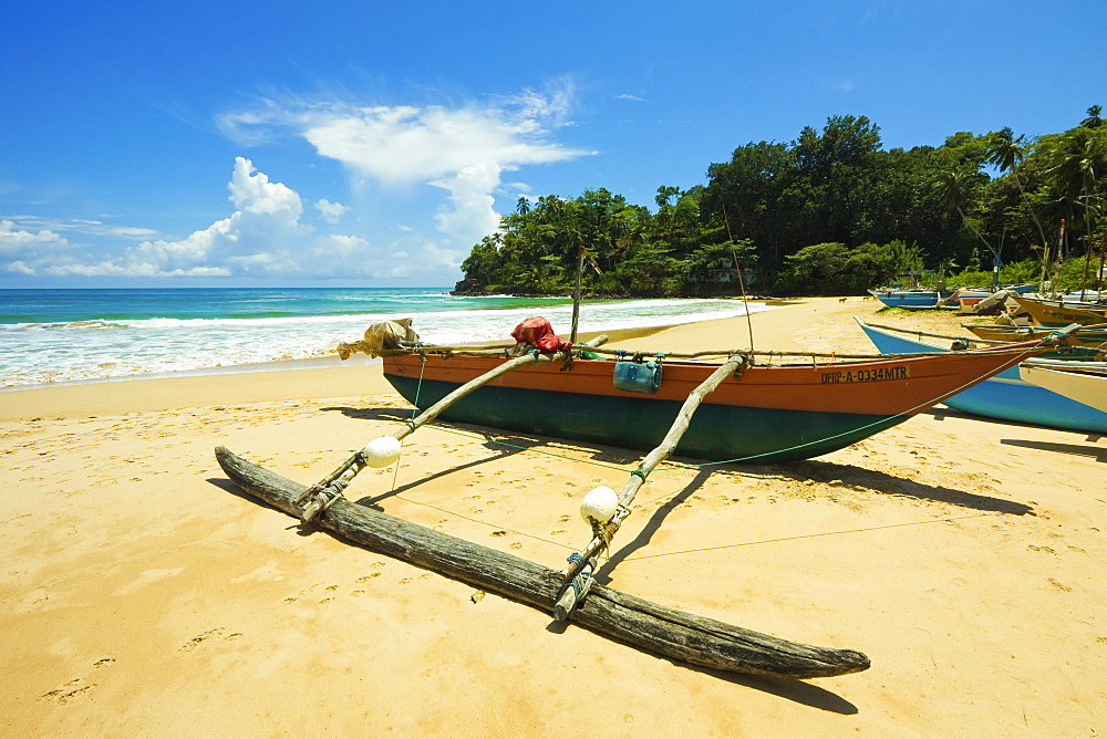 Outrigger fishing boat at this quiet south coast retreat beach, Talalla, near Matara, Southern Province, Sri Lanka, Asia