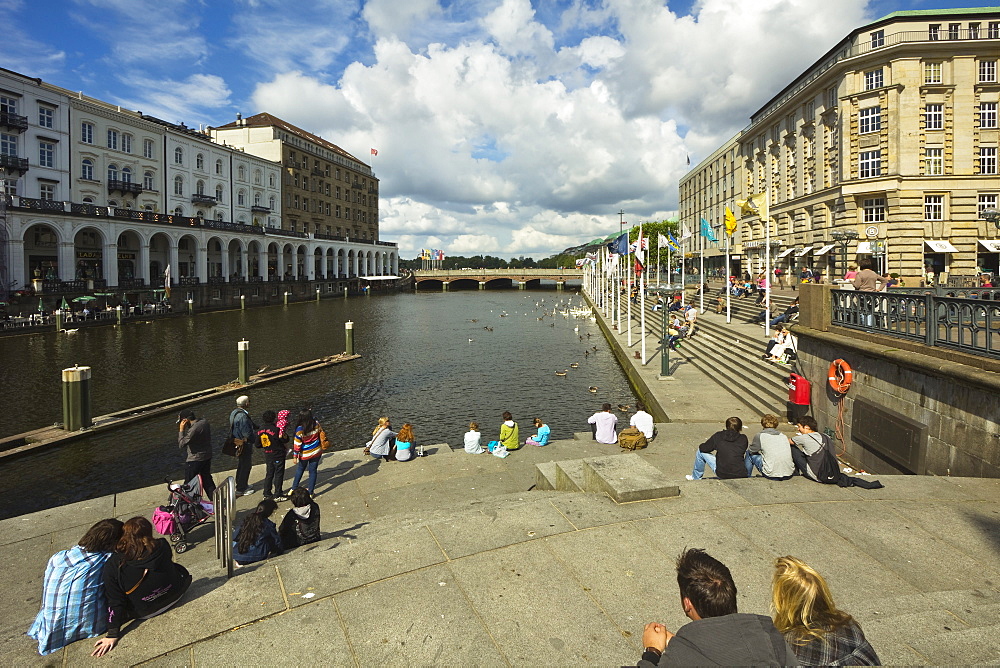 People sitting by the Alster River and the Reesendamm near the Rathausmarkt in this popular district of the city, Hamburg, Germany, Europe