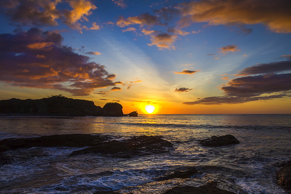 Sunset by the southern headland of beautiful Playa Pelada beach, Nosara, Nicoya Peninsula, Guanacaste Province, Costa Rica