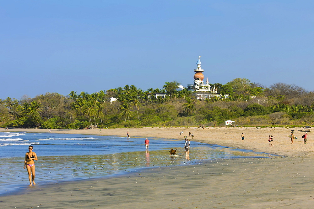 Walkers and the Nosara Beach Hotel at popular Playa Guiones beach, Nosara, Nicoya Peninsula, Guanacaste Province, Costa Rica, Central America