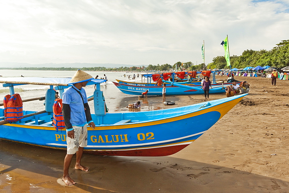 Outrigger fishing boats on west beach of the isthmus at this major beach resort on the south coast, Pangandaran, Java, Indonesia, Southeast Asia, Asia