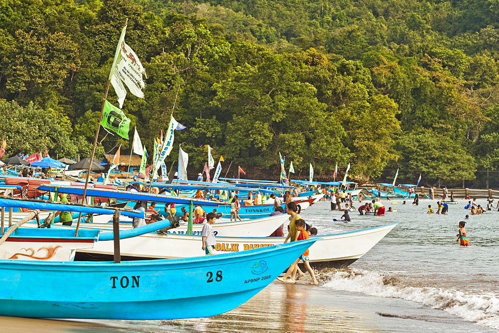 Outrigger fishing boats on west beach of the isthmus at this major beach resort on the south coast, Pangandaran, Java, Indonesia, Southeast Asia, Asia