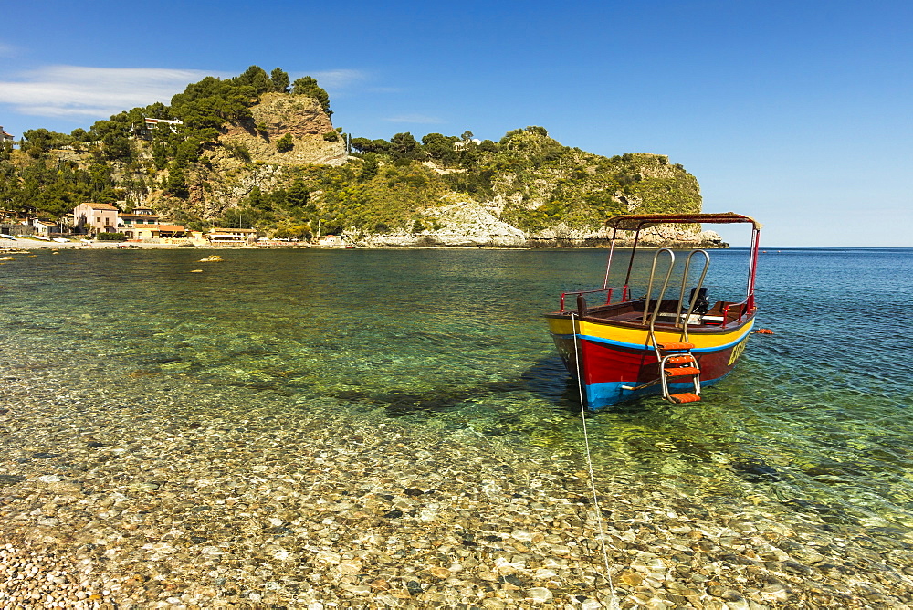 Excursion boat moored on pretty Isola Bella Bay in this popular northeast tourist town, Taormina, Catania Province, Sicily, Italy, Mediterranean, Europe