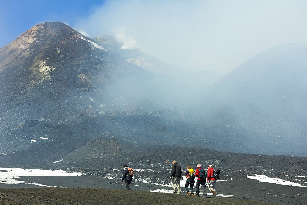 Hikers from the cablecar near the smoking summit of 3350m volcano Mount Etna during an active phase, Mount Etna, UNESCO World Heritage Site, Sicily, Italy, Mediterranean, Europe