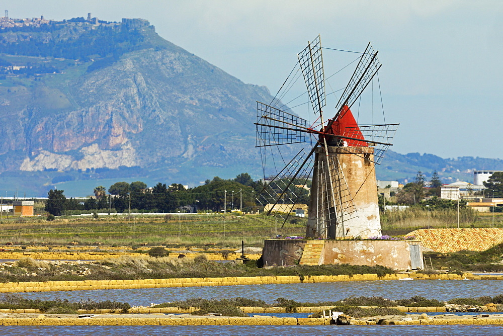 Windmill on Stagnone Lagoon in the salt pan area south of Trapani, with Mount Erice in the distance, Marsala, Sicily, Italy, Mediterranean, Europe