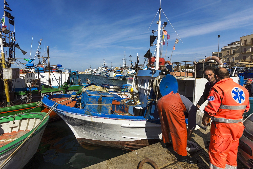 Fishermen and trawlers in the bustling port district of this major north western historic fishing town, Trapani, Sicily, Italy, Mediterranean, Europe