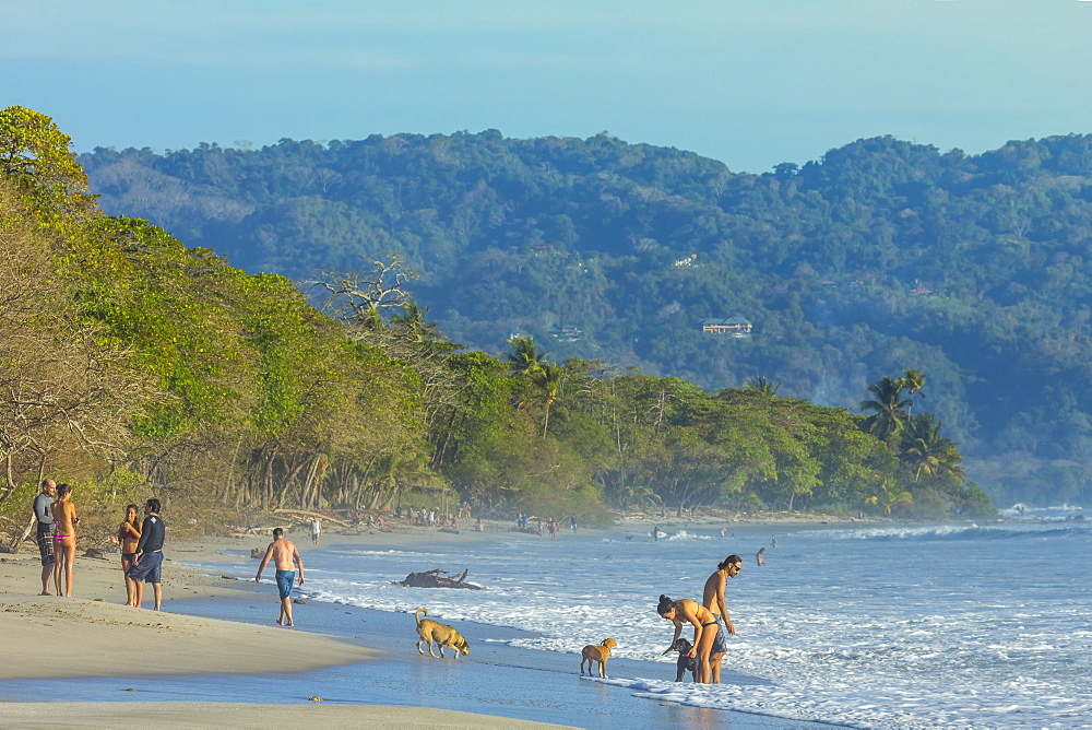 Beach walkers at this hip surf resort near Mal Pais, far south end of the Nicoya Peninsula, Santa Teresa, Puntarenas, Costa Rica, Central America