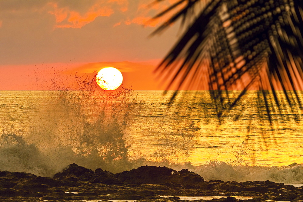 Sun going down behind surf spray at this resort near Mal Pais, southern Nicoya Peninsula, Santa Teresa, Puntarenas, Costa Rica, Central America