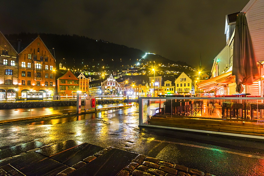 The Fjord Restaurant by Vagen Harbour with the Bryggen waterfront and funicular rail beyond, at night, Bergen, Hordaland, Norway, Scandinavia, Europe