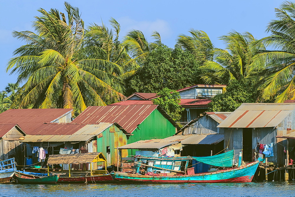 Fishing boats moored on the Praek Tuek Chhu River in this old French colonial river port, Kampot, Kampot Province, Cambodia, Indochina, Southeast Asia, Asia