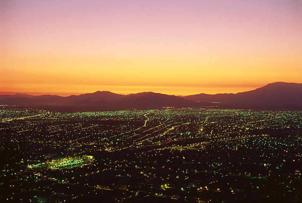 The city of Santiago seen from the summit of Cerro San Cristobal, 485m, at sunset, Chile, South America