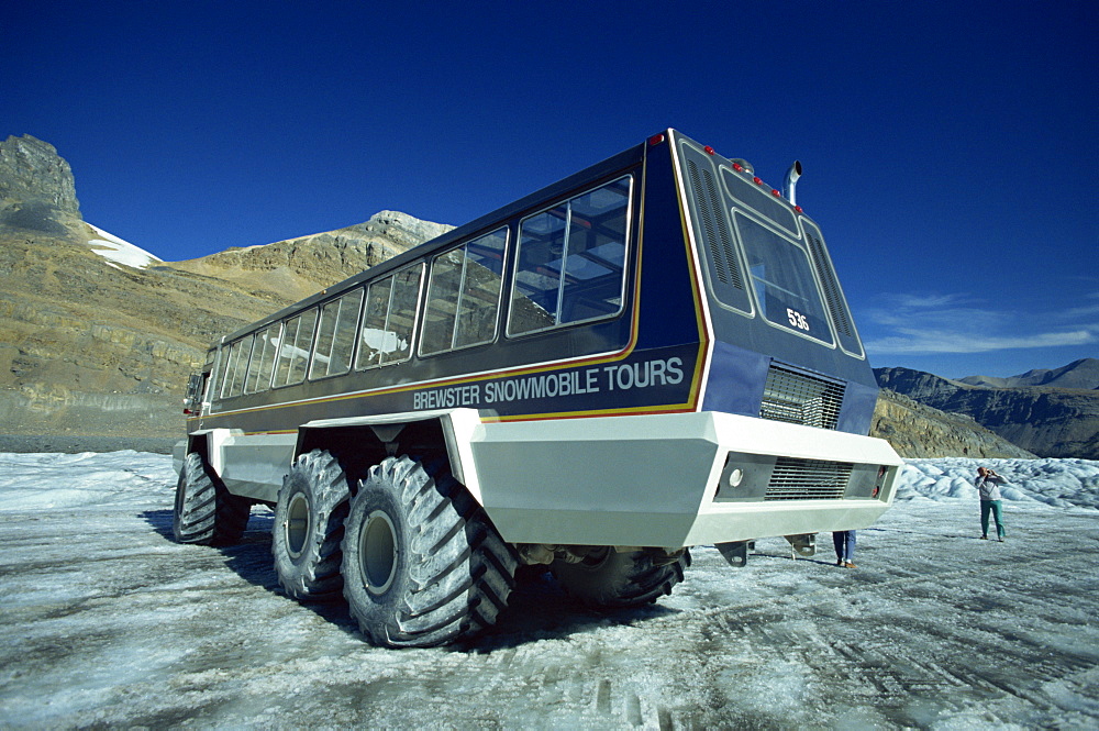 Snowmobile that takes tourists onto the Athabasca Glacier in Jasper National Park in the Rocky Mountains in British Columbia, Canada, North America